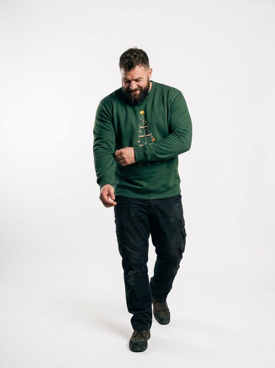 Man wearing the Scaffold Christmas Tree Jumper, a Christmas tree built from scaffolding