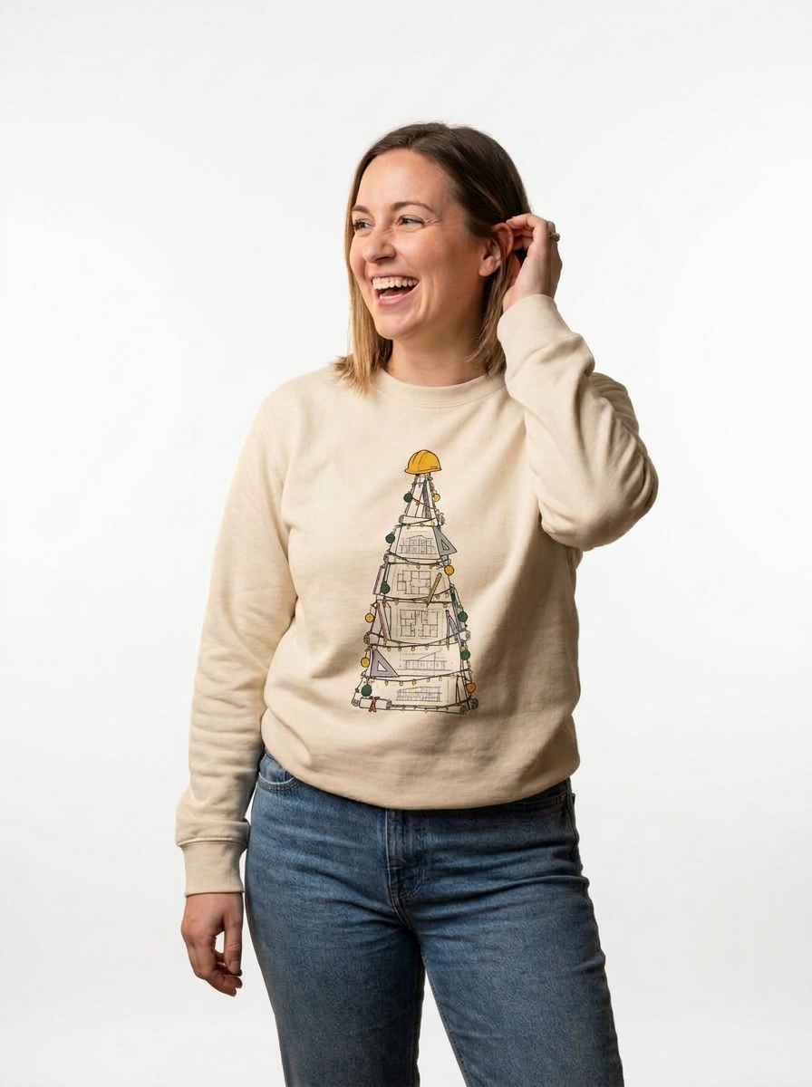 Woman wearing the Building Plans Christmas Tree Jumper, a Christmas tree drawn as building plans