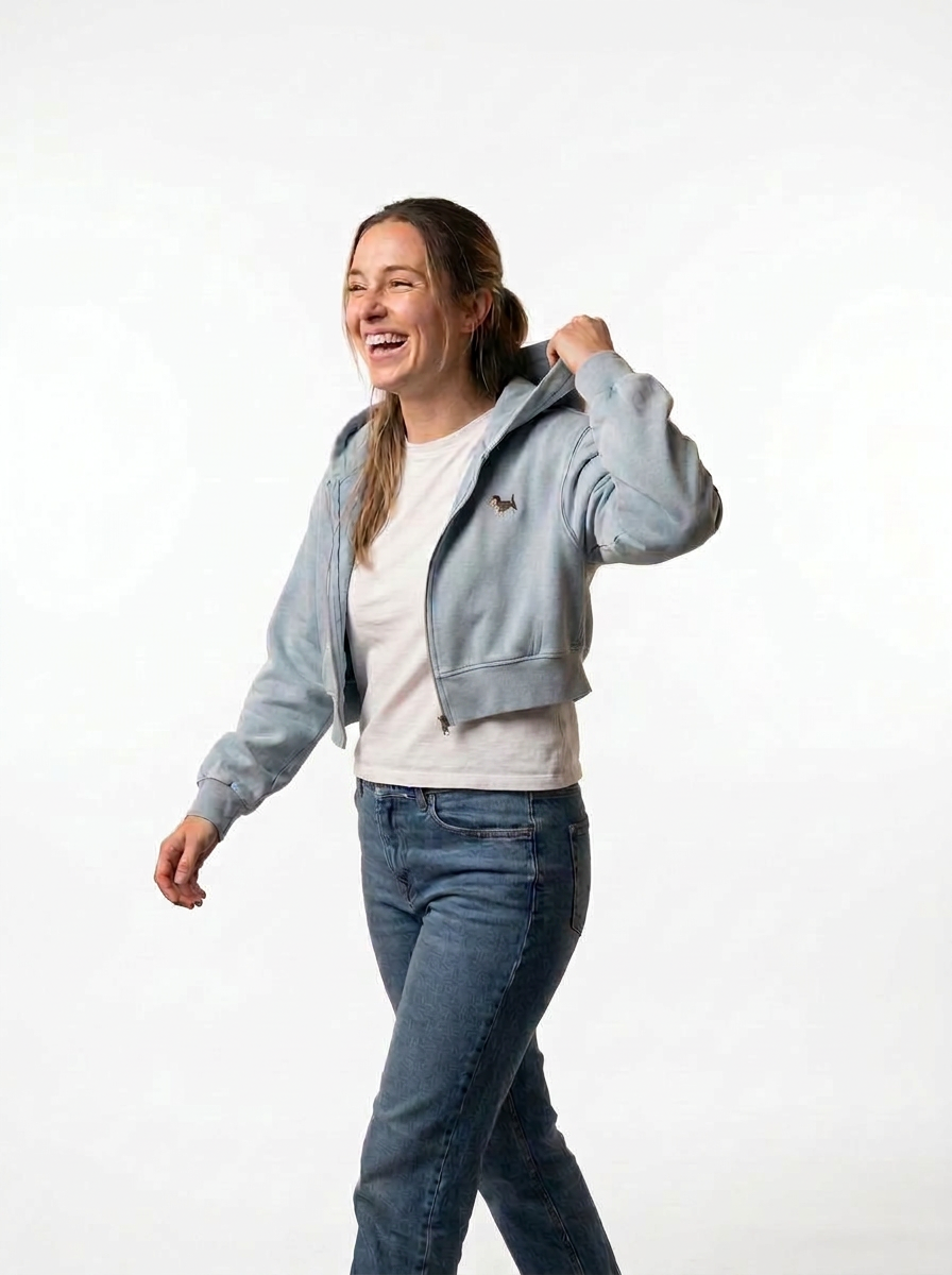 Woman wearing the cropped mineral wash zip hoodie with a miniature schnauzer print