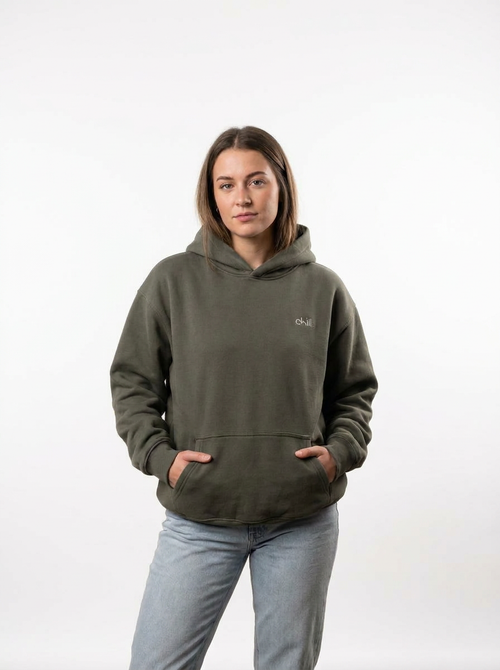 Woman standing in the chill. embroidered boxy fleece hoodie, hands in the front pocket