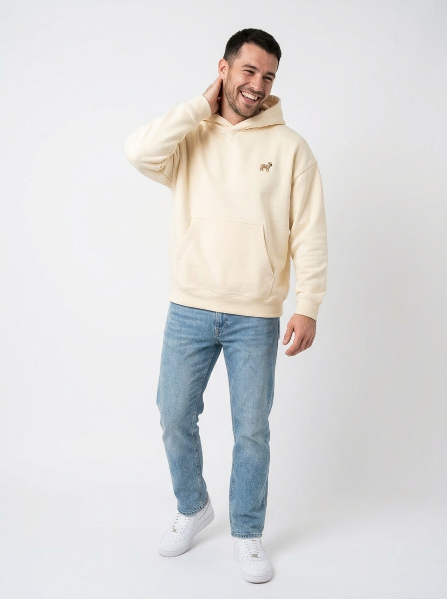 Man in the Apricot boxy fleece hoodie with a small embroidered-look French Bulldog on the chest