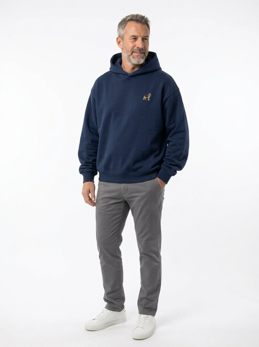 Man in the Navy oversized boxy fleece hoodie with a small embroidered-look German Shepherd on the chest