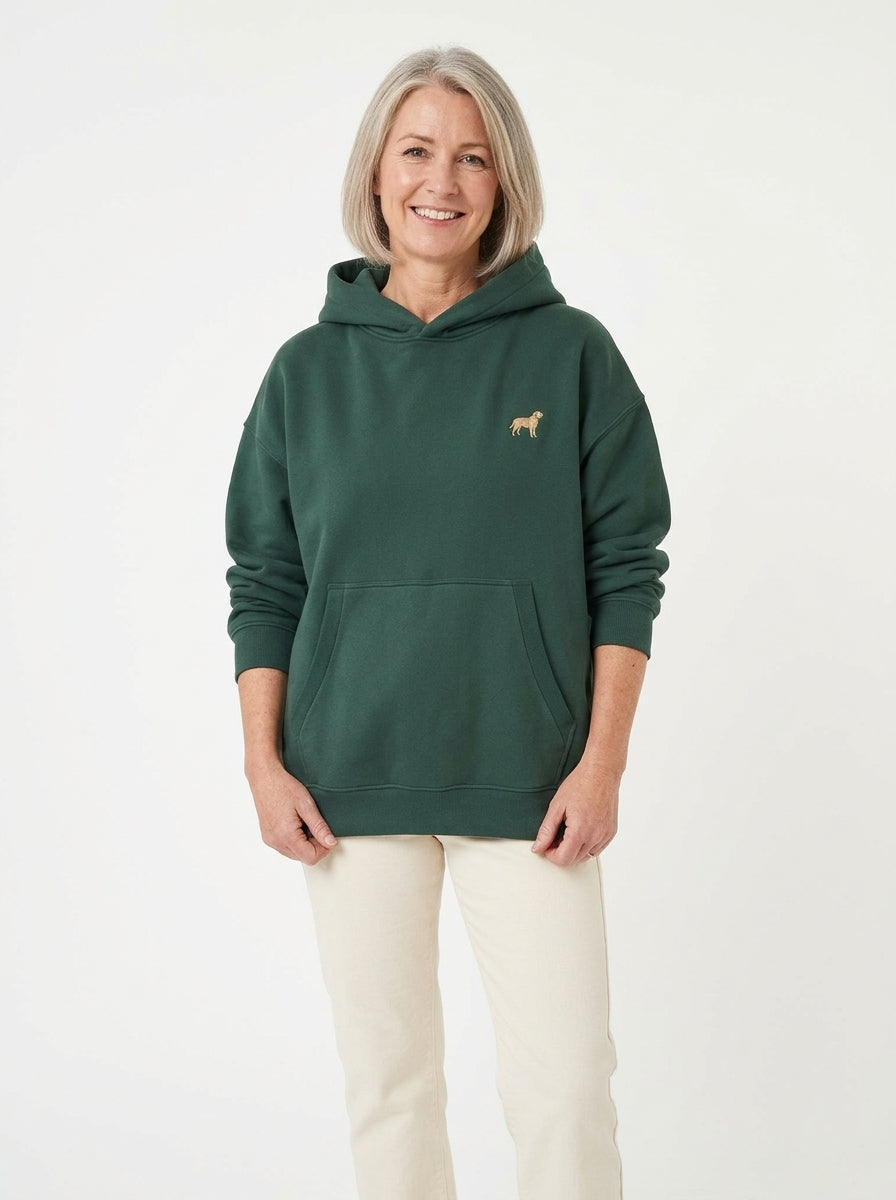Woman in the Dark Green boxy fleece hoodie with a small embroidered-look Labrador on the chest