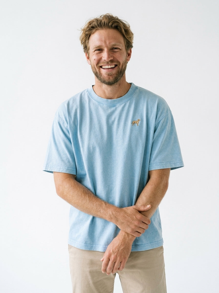 Man smiling in the Sky Blue mineral wash t-shirt with a small embroidered-look Labrador on the chest